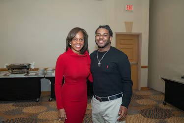 Honors Events — Woman in red and young man posing together